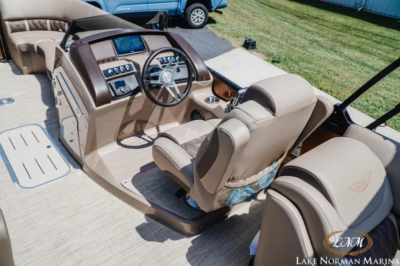 Slide: The Image of 2024 Bennington 24LXSFB boat interior with steering wheel and dashboard at Lake Norman Marina. - 10