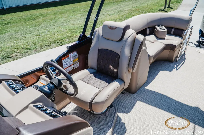Slide: The Image of 2024 Bennington 24LXSFB boat interior with luxurious seating and modern steering console. - 21
