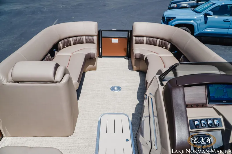 Slide: The Image of 2024 Bennington 24LXSFB pontoon boat interior with luxurious seating and modern dashboard. - 13