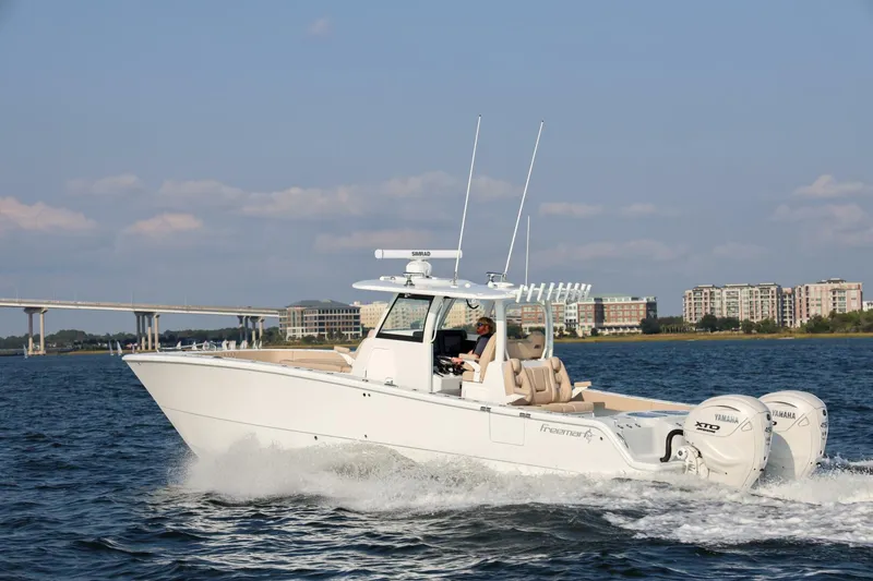 The Image of 2026 Freeman 35 boat cruising on water with cityscape background. - 1