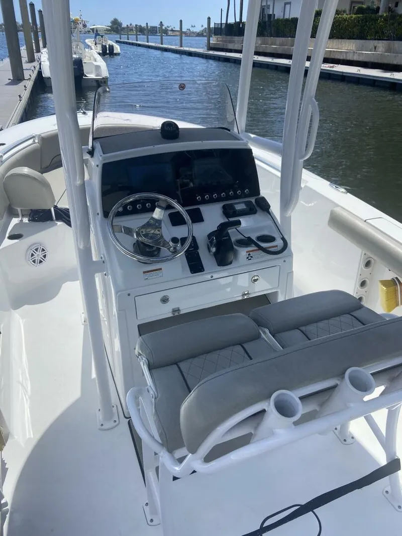 Slide: The Image of 2022 Sportsman Open 232 Center Console boat docked by the water. - 18