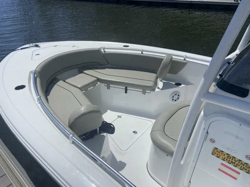 Slide: The Image of 2022 Sportsman Open 232 Center Console boat interior with cushioned seating. - 21
