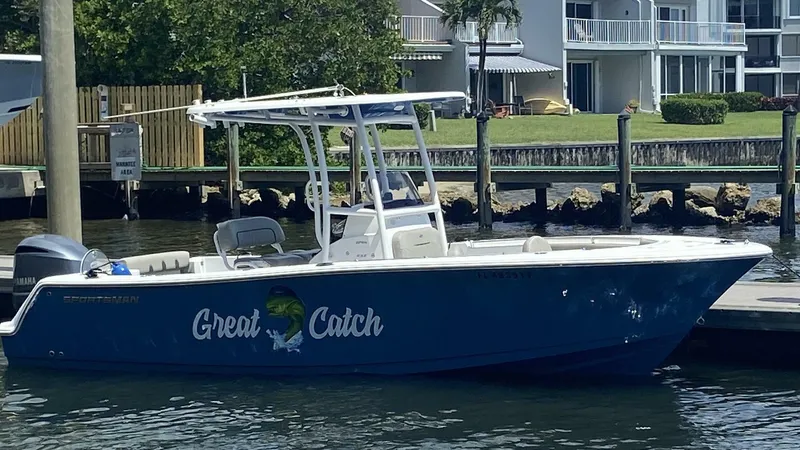 The Image of 2022 Sportsman Open 232 Center Console boat docked, labeled "Great Catch." - 1