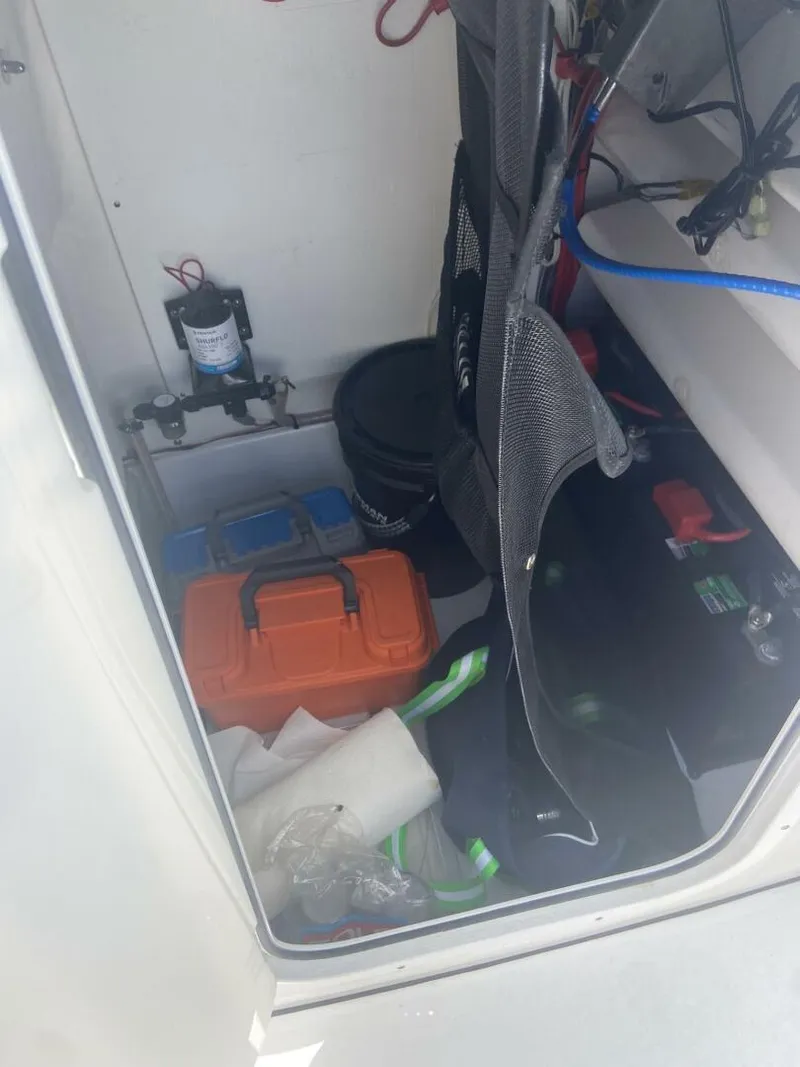 Slide: The Image of Storage compartment of 2022 Sportsman Open 232 Center Console with equipment and supplies. - 16
