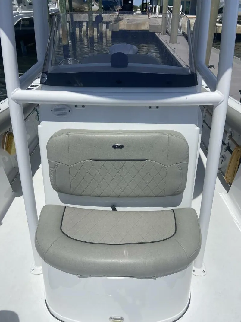 Slide: The Image of 2022 Sportsman Open 232 Center Console boat interior with cushioned seating. - 15