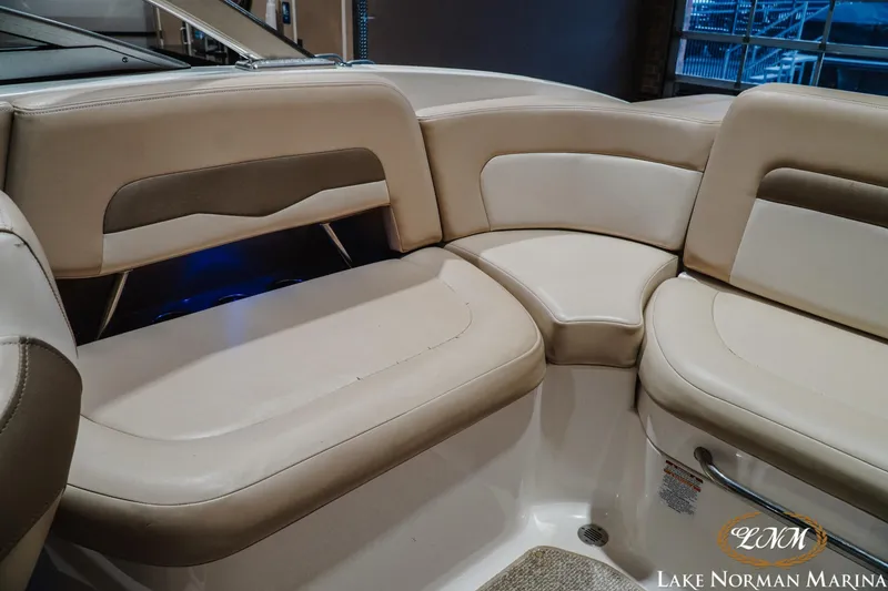 Slide: The Image of 2011 Chaparral 246 SSi boat interior with beige seating at Lake Norman Marina. - 18