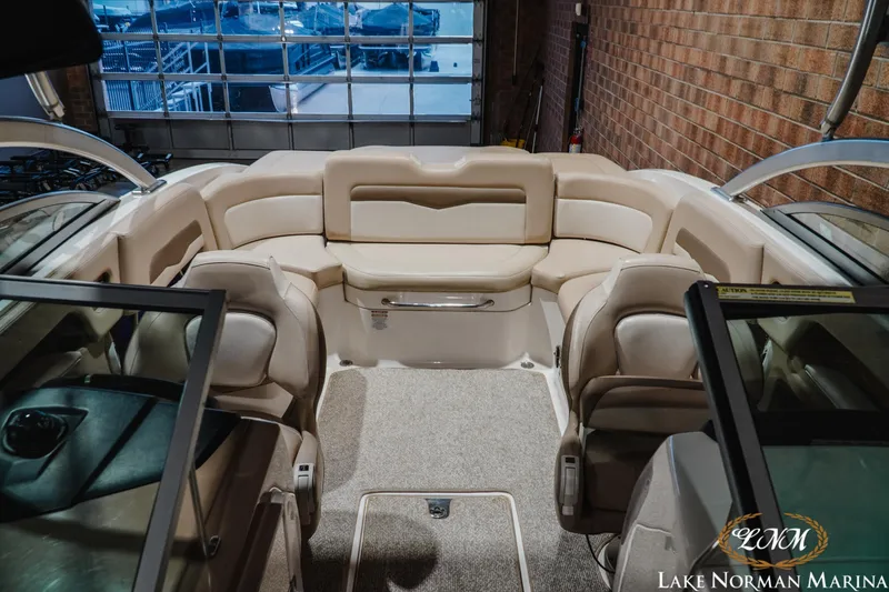 Slide: The Image of 2011 Chaparral 246 SSi boat interior with beige seating at Lake Norman Marina. - 15