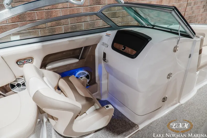 Slide: The Image of Interior of 2011 Chaparral 246 SSi boat with beige seating and modern dashboard. - 13