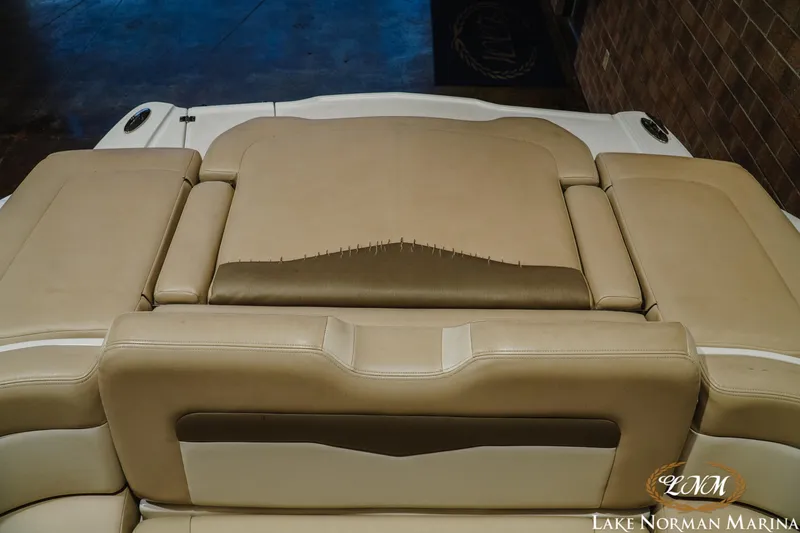 Slide: The Image of 2011 Chaparral 246 SSi boat with beige upholstery and visible wear. - 21