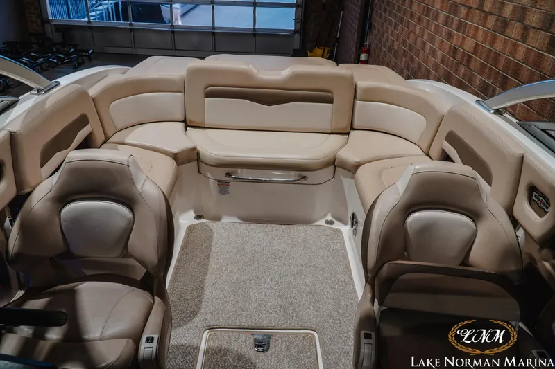 Slide: The Image of Interior of a 2011 Chaparral 246 SSi boat with beige seating and carpeted floor. - 16
