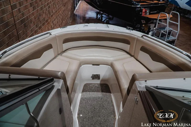 Slide: The Image of 2011 Chaparral 246 SSi boat interior with beige seating at Lake Norman Marina. - 14