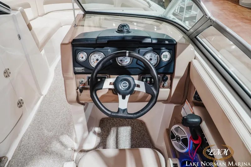 Slide: The Image of Interior view of 2011 Chaparral 246 SSi boat dashboard with steering wheel and gauges. - 12