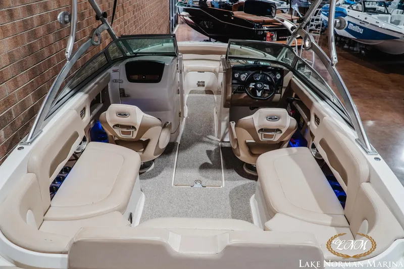 Slide: The Image of Interior view of a 2011 Chaparral 246 SSi boat with beige seating and steering console. - 9
