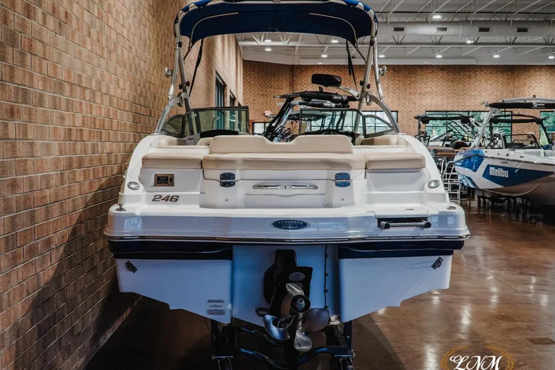 Slide: The Image of 2011 Chaparral 246 SSi boat displayed indoors, showcasing rear view and seating area. - 8