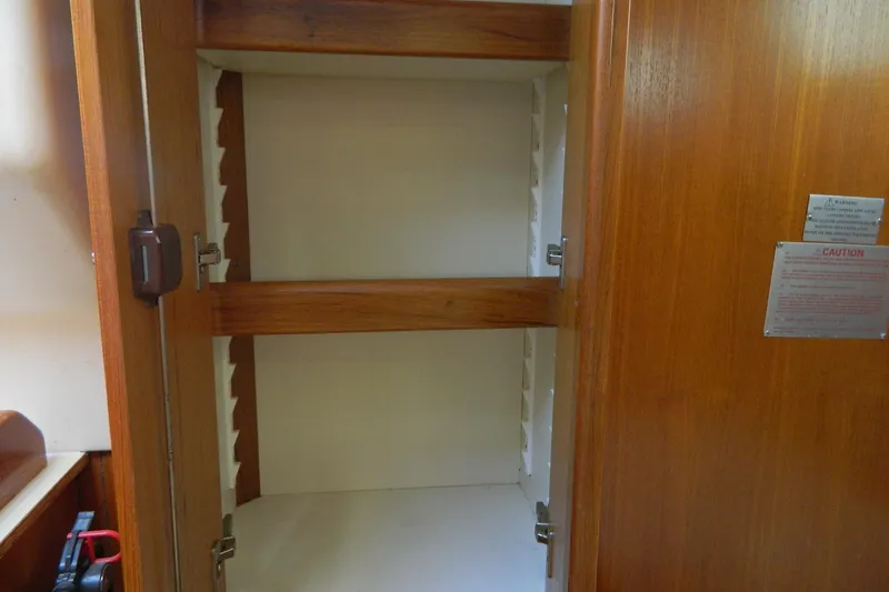 Slide: The Image of Empty wooden cabinet inside a 2007 Hunter 41 AC sailboat. - 20