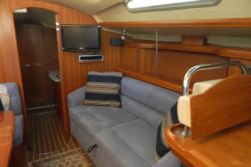 Slide: The Image of Interior of 2007 Hunter 41 AC yacht with cozy seating and wooden finishes. - 15