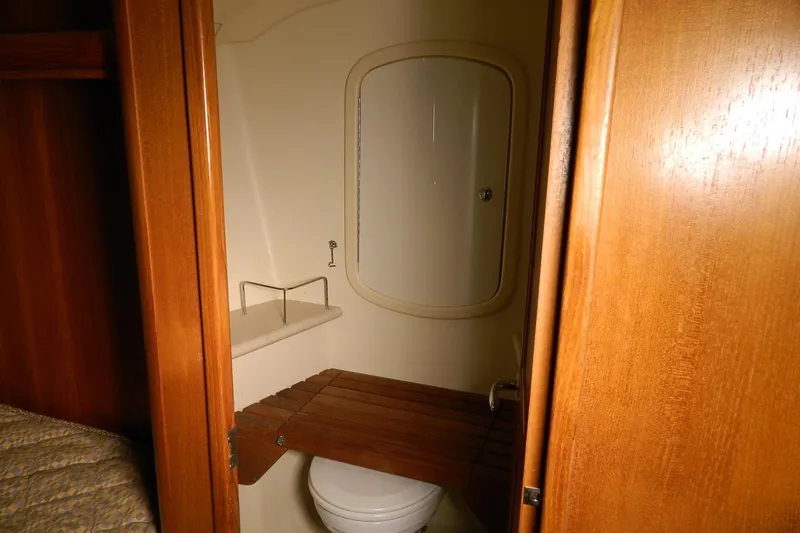 Slide: The Image of Interior of 2007 Hunter 41 Aft Cockpit yacht bathroom with wooden accents. - 26