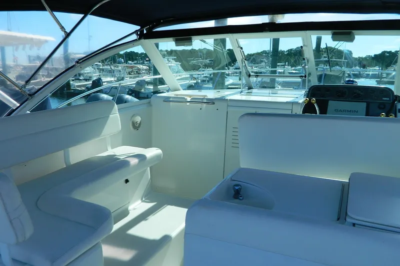 Slide: The Image of 1999 Tiara Yachts 2900 Coronet interior with seating and helm, docked at marina. - 4