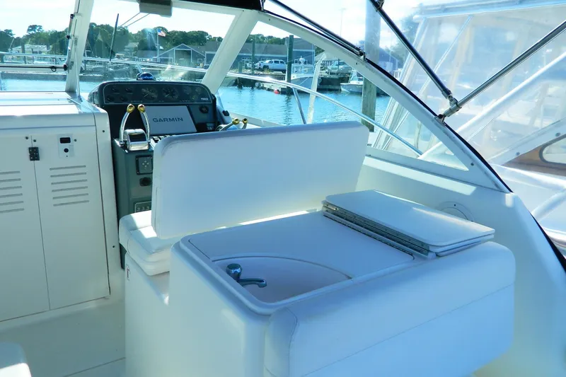 Slide: The Image of 1999 Tiara Yachts 2900 Coronet cockpit with helm, seating, and Garmin navigation system. - 12
