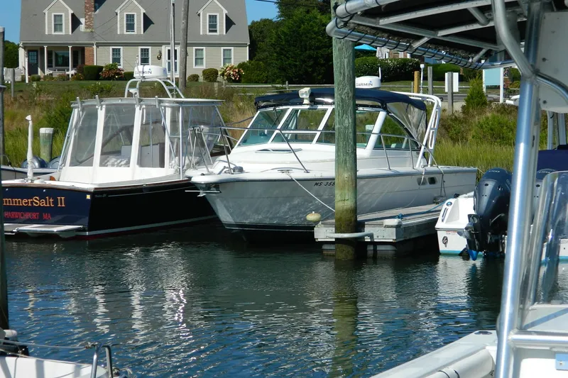 The Image of 1999 Tiara Yachts 2900 Coronet docked at marina with neighboring boats. - 2