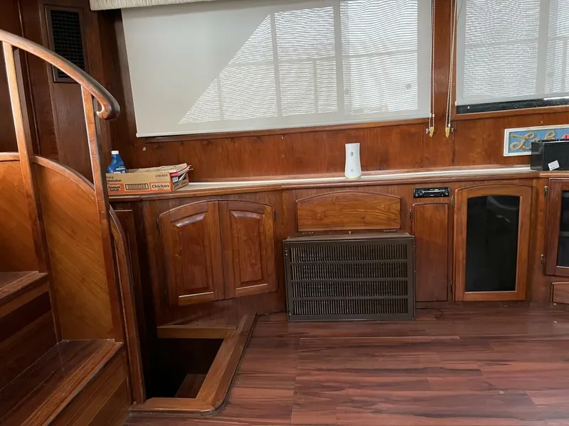 Slide: The Image of Interior of 1987 Californian 42 Motor Yacht with wooden cabinetry and stairs. - 28