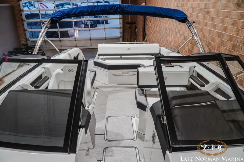 Slide: The Image of 2024 Cobalt R8 boat interior with seating and blue canopy at Lake Norman Marina. - 20
