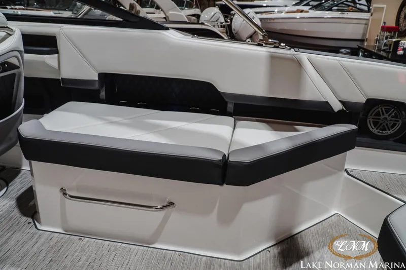 Slide: The Image of 2024 Cobalt R8 boat interior seating at Lake Norman Marina, featuring sleek white and black upholstery. - 13