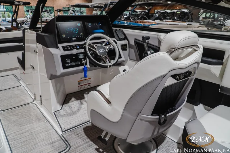 Slide: The Image of 2024 Cobalt R8 boat interior with modern dashboard and steering wheel at Lake Norman Marina. - 16
