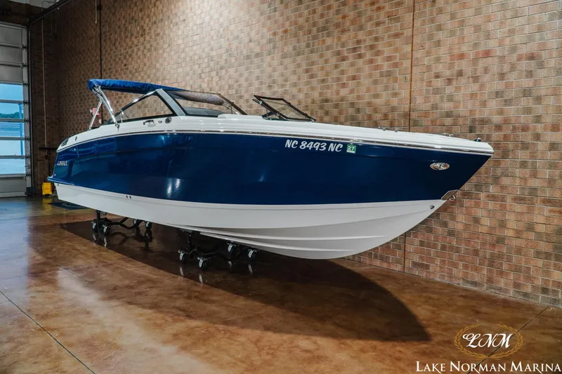 Slide: The Image of 2024 Cobalt R8 boat in showroom, blue and white design, Lake Norman Marina. - 3