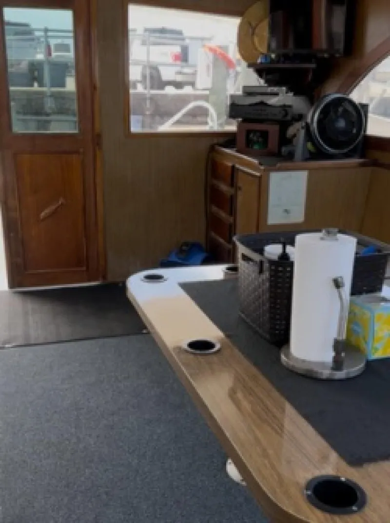 Slide: The Image of Interior of a 1987 Miller Sportfish 55 boat with wooden furnishings and nautical equipment. - 18