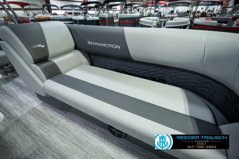 Slide: The Image of 2027 Bennington 22 SSR boat interior with gray seating and logo, displayed at Reeder-Trausch Marine. - 49