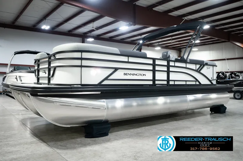 Slide: The Image of 2027 Bennington 22 SSR pontoon boat in showroom, featuring sleek design and modern amenities. - 1