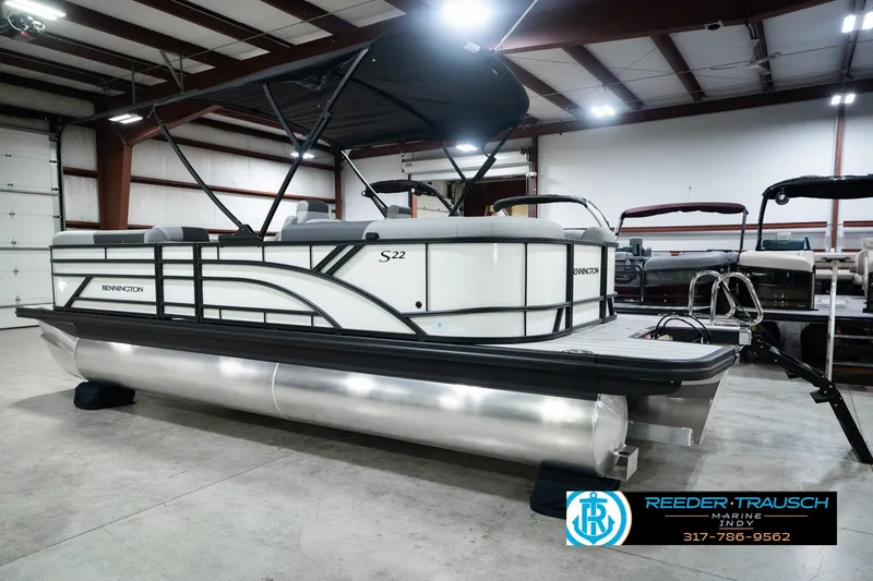 Slide: The Image of 2027 Bennington 22 SSR pontoon boat in showroom, featuring sleek design and modern amenities. - 10