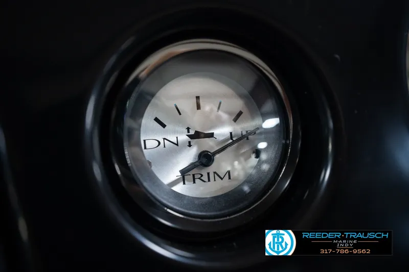 Slide: The Image of Close-up of a 2027 Bennington 22 SSR trim gauge, displaying "DN" and "UP" indicators. - 41