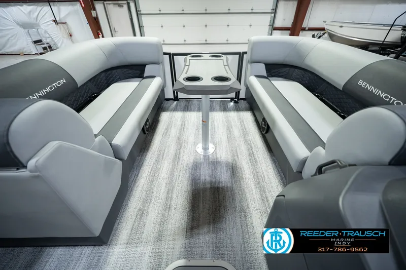 Slide: The Image of 2027 Bennington 22 SSR pontoon boat interior with gray seating and central table. - 25