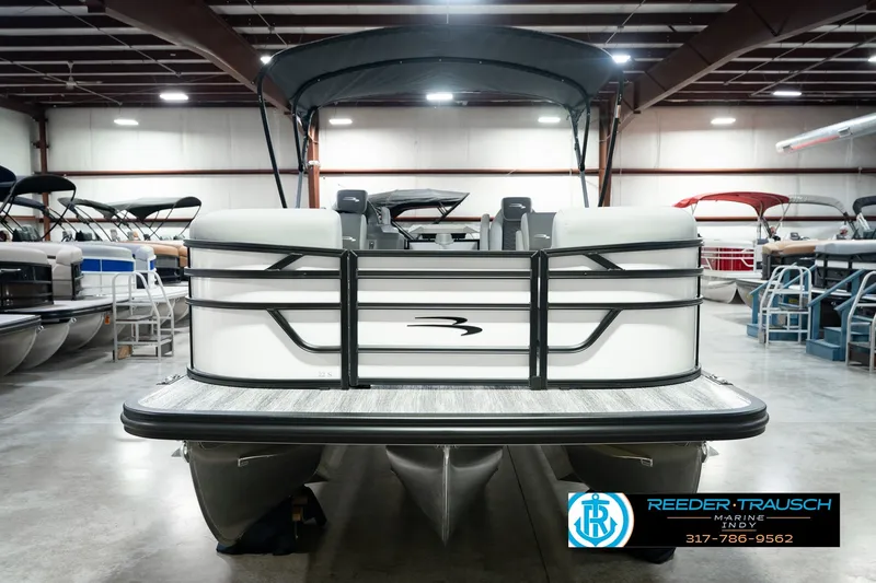 Slide: The Image of 2027 Bennington 22 SSR pontoon boat in showroom, featuring sleek design and modern amenities. - 4