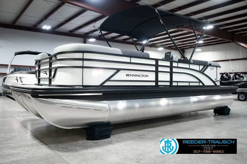 Slide: The Image of 2027 Bennington 22 SSR pontoon boat in showroom, featuring sleek design and modern amenities. - 2