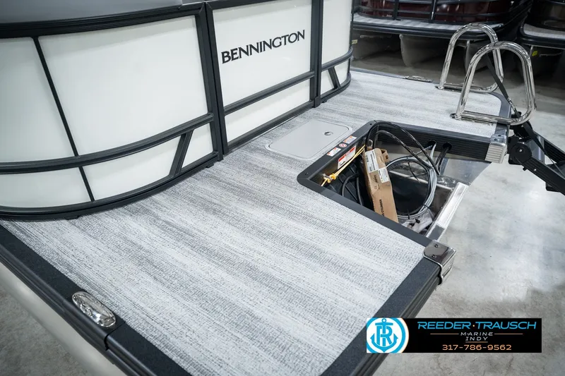 Slide: The Image of 2027 Bennington 22 SSR pontoon boat deck with storage compartment and ladder. - 59