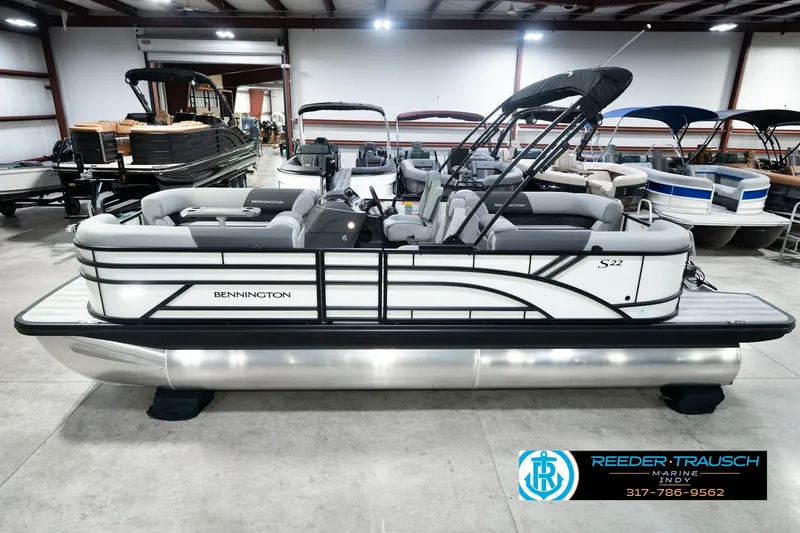 The Image of 2027 Bennington 22 SSR pontoon boat in showroom, featuring sleek design and modern seating. - 0