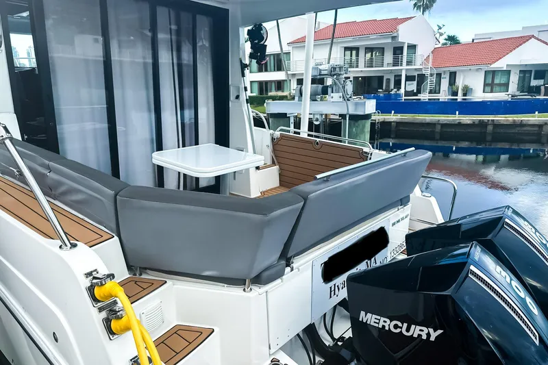 Slide: The Image of 2021 Beneteau America Antares 11 boat with seating area and Mercury engines. - 4