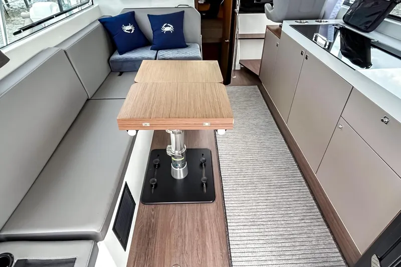 Slide: The Image of Interior of 2021 Beneteau America Antares 11 with modern seating and wooden table. - 6