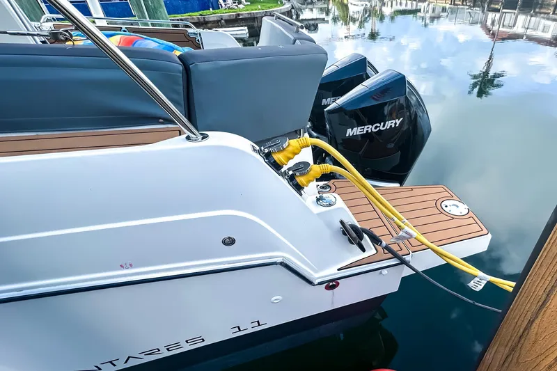 Slide: The Image of 2021 Beneteau America Antares 11 with Mercury engines docked, featuring a sleek design. - 3