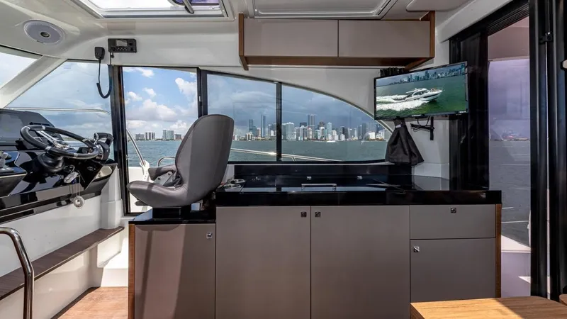 Slide: The Image of Interior of the Beneteau Antares 11 with a modern helm and city skyline view. - 19