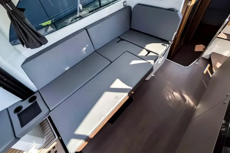 Slide: The Image of Interior view of 2021 Beneteau America Antares 11 with gray seating and modern design. - 5