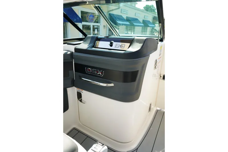 Slide: The Image of 2025 Chaparral 270 OSX helm station with sleek design and modern controls. - 6