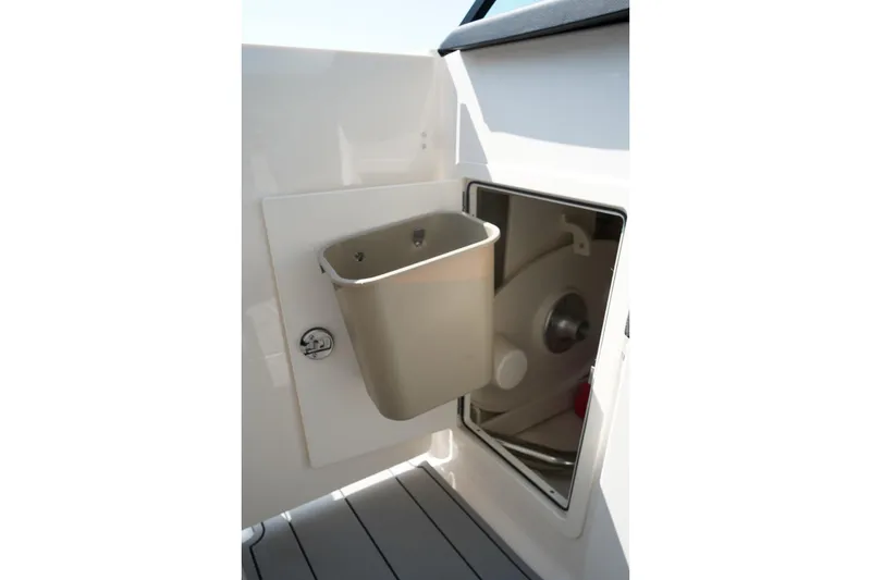 Slide: The Image of Storage compartment with trash bin on 2025 Chaparral 270 OSX boat. - 15