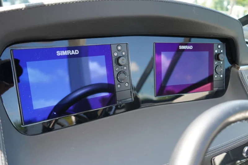 Slide: The Image of Dual Simrad displays on 2025 Chaparral 270 OSX boat dashboard. - 8