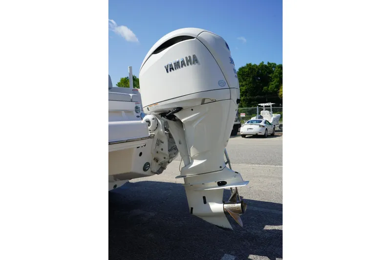 Slide: The Image of 2025 Chaparral 270 OSX with Yamaha outboard motor in a parking lot. - 10