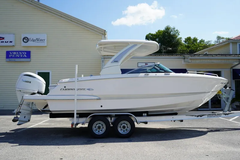 The Image of 2025 Chaparral 270 OSX boat on trailer, parked outside a dealership. - 0