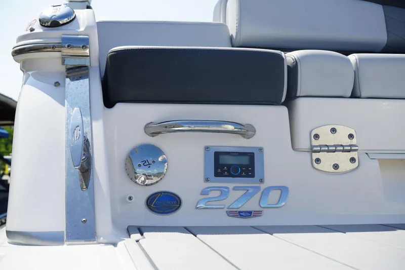 Slide: The Image of 2025 Chaparral 270 OSX boat interior detail with chrome accents and seating. - 3